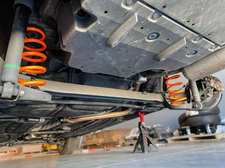 A prius on jacks with new Prius Offroad heavy duty lift springs installed