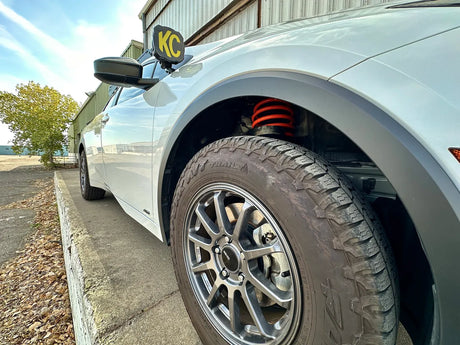 Close up view of a prius with a Prius Offroad lift kit installed